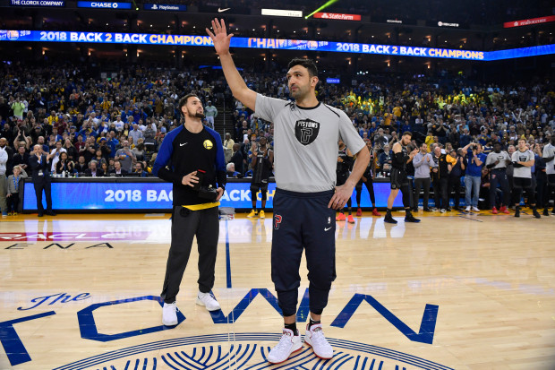 Detroit Pistons' Zaza Pachulia (27) acknowledges the crowd before Golden State Warriors' Klay Thompson (11) hands him his 2018 NBA Championship ring before their NBA game at Oracle Arena in Oakland, Calif. on Sunday, March 24, 2019. (Jose Carlos Fajardo/Bay Area News Group)