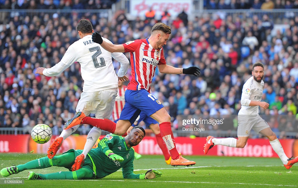 MADRID, SPAIN - FEBRUARY 27:  Saul Niguez of Club Atletico de Madrid is tackled by Keylor Navas and Rafael Varane of Real Madrid during the La Liga match between Real Madrid CF and Club Atletico de Madrid at Estadio Santiago Bernabeu on February 27, 2016 in Madrid, Spain.  (Photo by Denis Doyle/Getty Images)