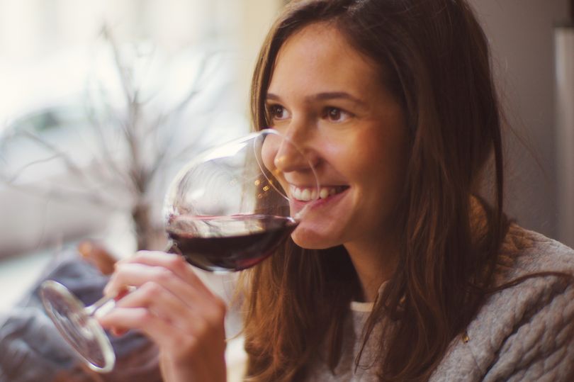 Pretty-happy-woman-drinking-wine