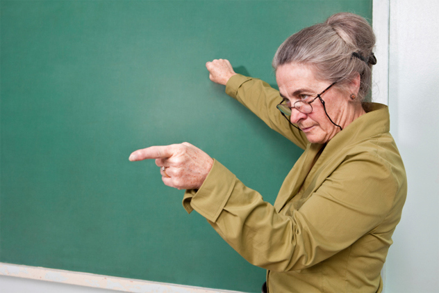 Strict teacher pointing at student