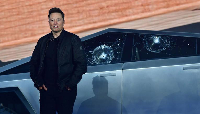 Tesla co-founder and CEO Elon Musk stands in front of the shattered windows of the newly unveiled all-electric battery-powered Tesla's Cybertruck at Tesla Design Center in Hawthorne, California on November 21, 2019. (Photo by FREDERIC J. BROWN / AFP) (Photo by FREDERIC J. BROWN/AFP via Getty Images)