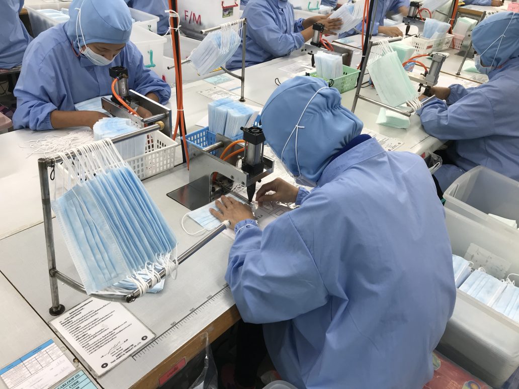 Workers produce masks at the Thai Hospital Product Company Ltd. factory in Bangkok on January 30, 2020. - A Thai surgical mask factory, producing 10 million masks a month, increased working hours to cope with the rising demand following an outbreak of SARS-like virus in China, with their product exported mostly to US and Europe the rest sold on the domestic market. (Photo by Jonathan KLEIN / AFP)