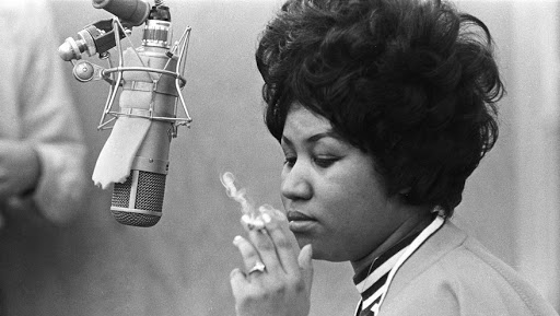 MUSCLE SHOALS, AL - JANUARY 9: Singer Aretha Franklin smokes as cigarette as she works in the studio by a microphone at Muscle Shoals Studios on January 9, 1969 in Muscle Shoals, Alabama. (Photo by Michael Ochs Archives/Getty Images)