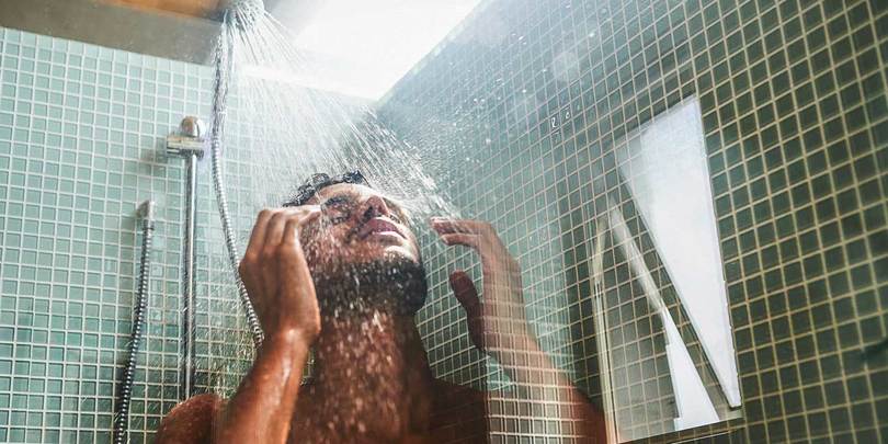 Cropped shot of a handsome young man having a refreshing shower at home
954670786