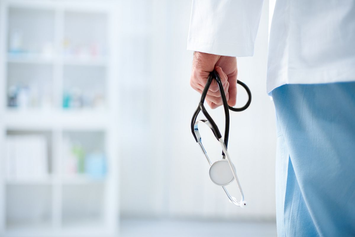 Doctor with stethoscope in a hospital, back view