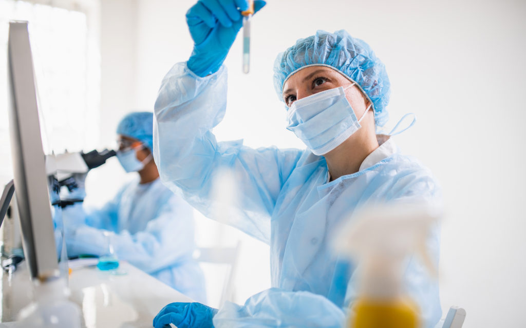 Scientists wearing full protective suit working in the laboratory