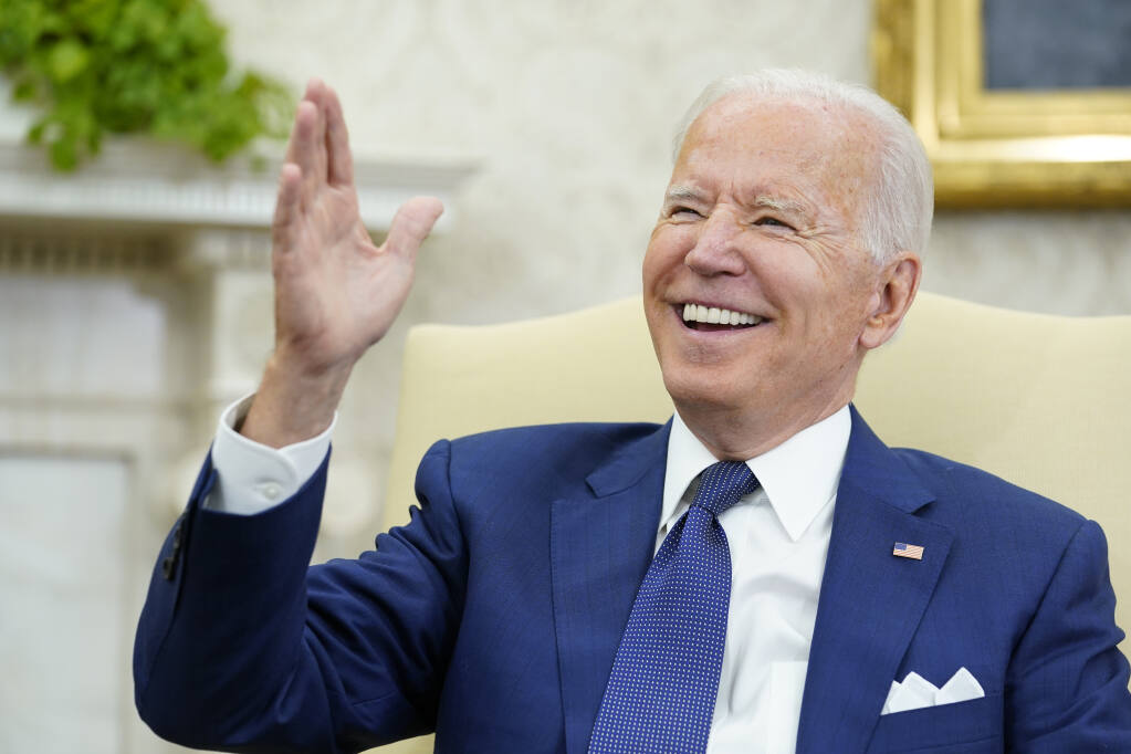 President Joe Biden laughs during his meeting with Iraqi Prime Minister Mustafa al-Kadhimi in the Oval Office of the White House in Washington, Monday, July 26, 2021. (AP Photo/Susan Walsh)