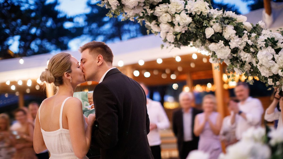 3-Bride-and-groom-kiss-at-their-wedding-reception