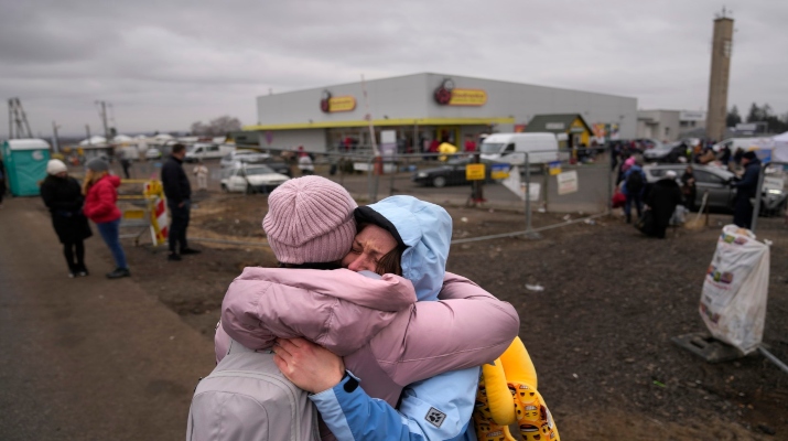 A woman weeps after finding a friend, who also fled Ukraine, at the border crossing in Medyka, Poland, Saturday, March 5, 2022. The Russian military initiated a temporary cease-fire in two areas of Ukraine to allow civilians to evacuate, Russian state media reported Saturday, the first breakthrough in allowing people to escape the war. (AP Photo/Markus Schreiber)