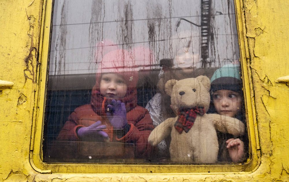 Ukrainian children ride an evacuation train through Kyiv as it travels west toward Lviv as Russian attacks against Ukrainian targets continued, March 3, 2022. Many thousands of Ukrainians, fearful of the war, are leaving their homes on a slow journey west, enduring difficulties but also buoyed by the generosity of their countrymen. (Lynsey Addario/The New York Times)ÑNO SALESÑ