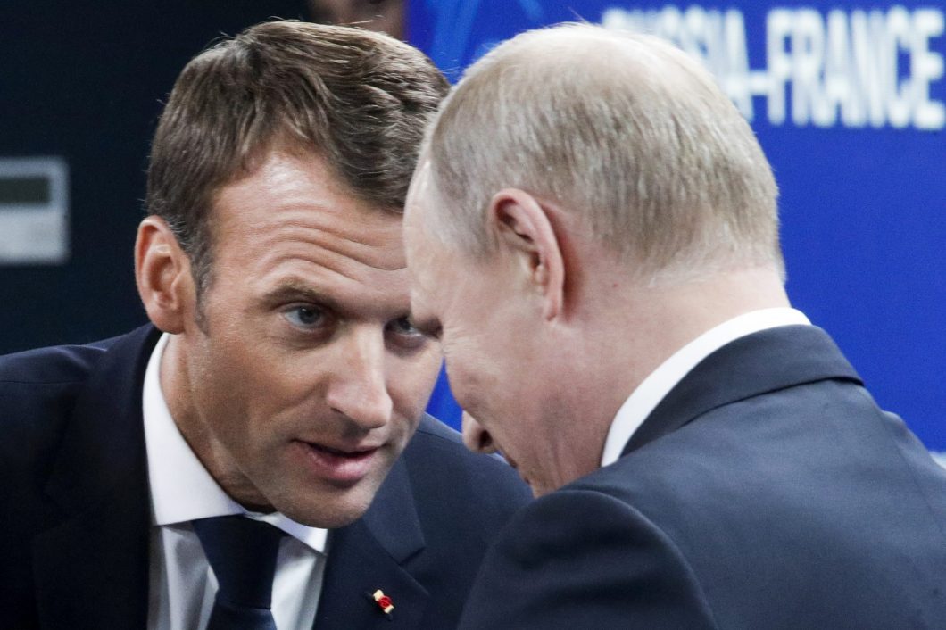 French President Emmanuel Macron (left) and Russian President Vladimir Putin attend a meeting with Russian and French business people during the St. Petersburg International Economic Forum on Friday.