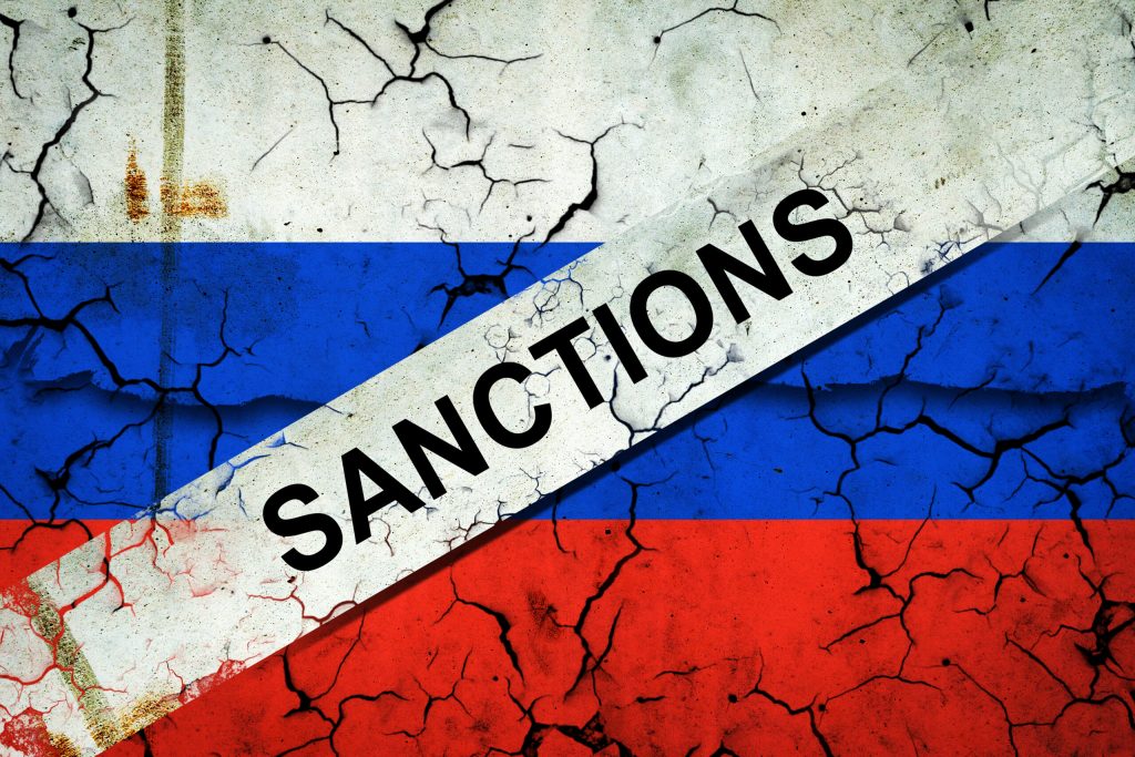 Cracked flag of Russia, crossed out, the word Sanctions. Russian aggression. Politics. Economy Economic crisis. The collapse of the economy.