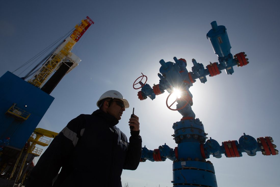 A worker speaks on a handheld transceiver at a gas well near to the Gazprom PJSC gas drilling rig in the Kovyktinskoye gas field, part of the Power of Siberia gas pipeline project, near Irkutsk, Russia, on Wednesday, April 7, 2021. Built by Russian energy giant Gazprom PJSC, the pipeline runs about 3,000 kilometers (1,864 miles) from the Chayandinskoye and Kovyktinskoye gas fields in the coldest part of Siberia to Blagoveshchensk, near the Chinese border. Photographer: Andrey Rudakov/Bloomberg via Getty Images