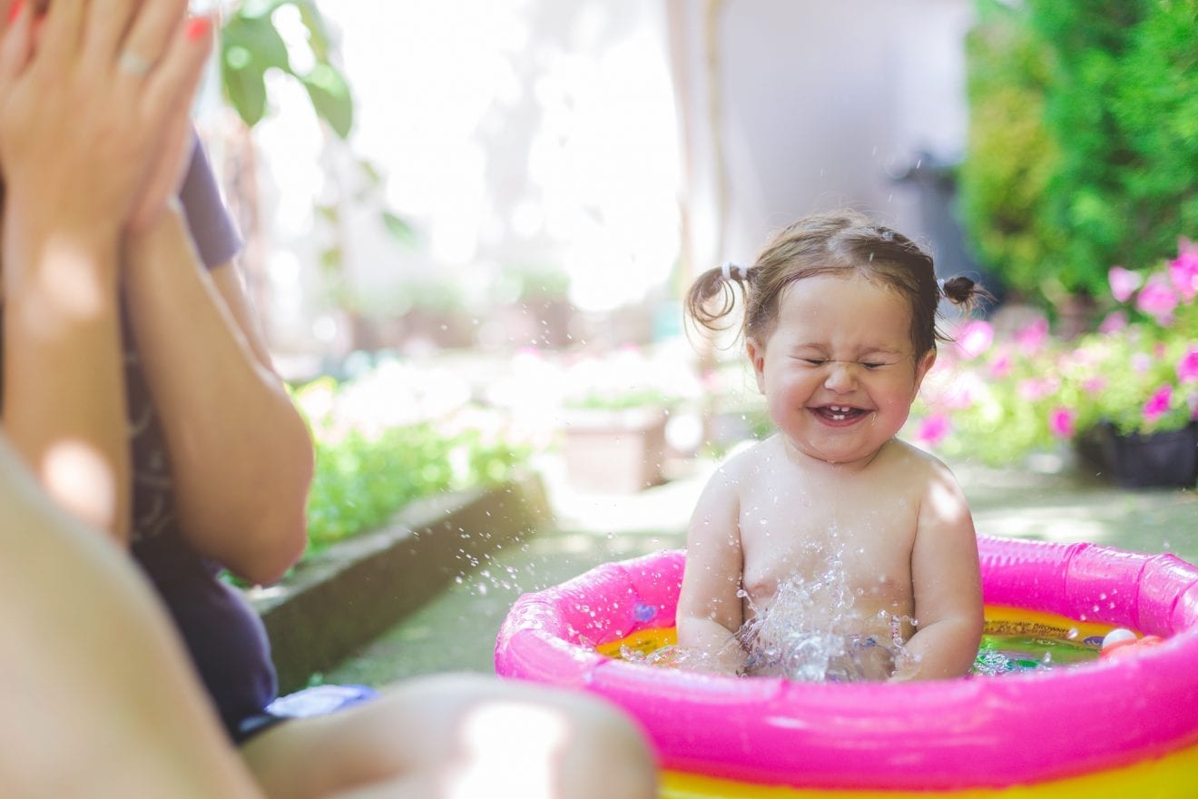 baby-in-swimwear-playing-in-baby-pool-546443310_2125x1416