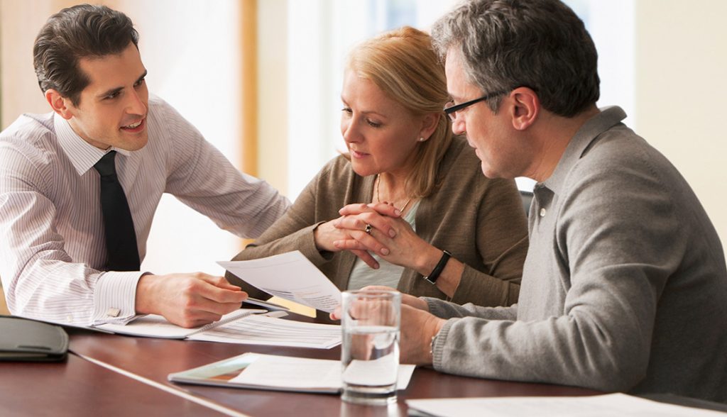 Counselor going over papers with older couple