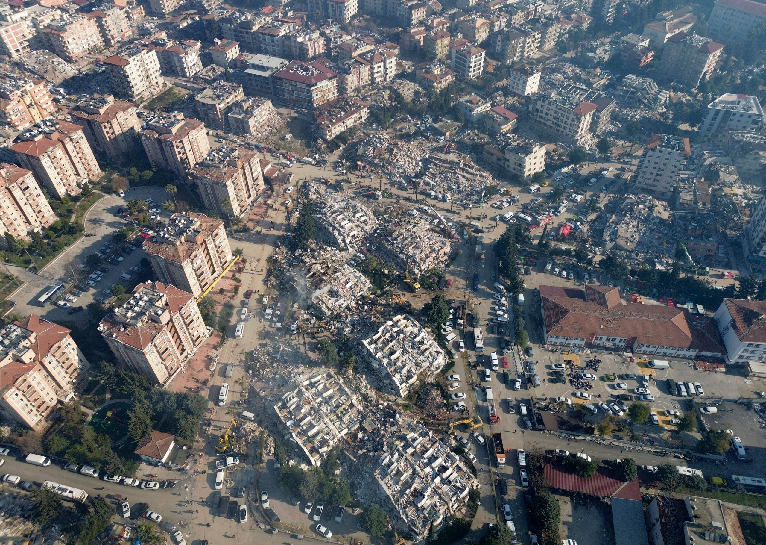 Aerial photo showing the destruction in Hatay city center, southern Turkey, Thursday, Feb. 9, 2023. Thousands who lost their homes in a catastrophic earthquake huddled around campfires and clamored for food and water in the bitter cold, three days after the temblor and series of aftershocks hit Turkey and Syria. (IHA via AP)