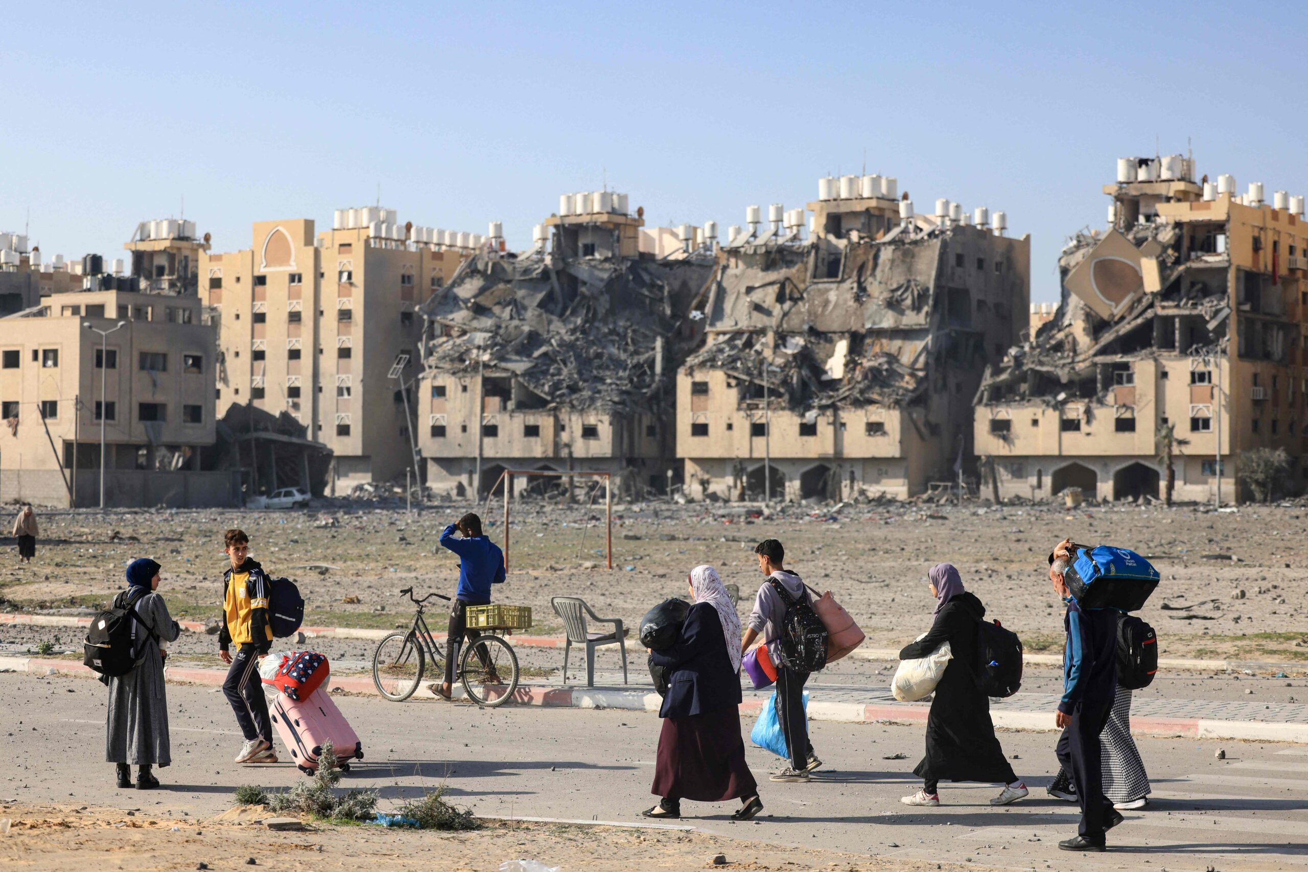 Residents of the Qatari-funded Hamad Town residential complex in Khan Yunis in the southern Gaza Strip, carry some of their belongings as they flee their homes after an Israeli strike, on December 2, 2023. A temporary truce between Israel and Hamas expired on December 1, with the Israeli army saying combat operations had resumed, accusing Hamas of violating the operational pause. (Photo by MAHMUD HAMS / AFP)