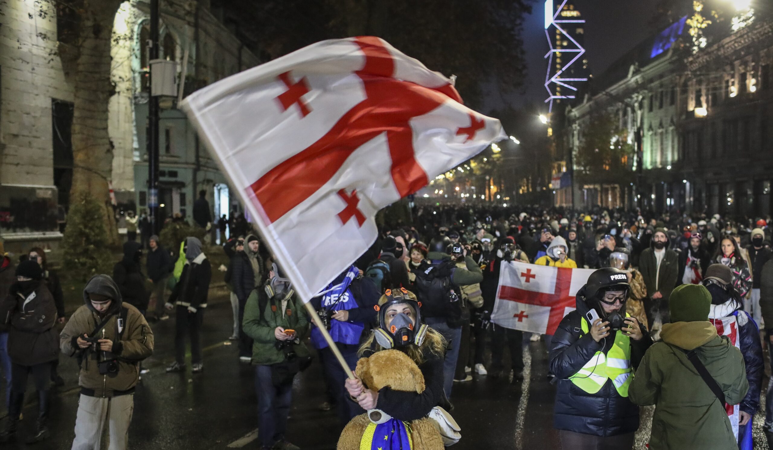 epa11761270 A supporter of the Georgian opposition holds a Georgian flag during a protest in front of the Parliament building in Tbilisi, Georgia, 06 December 2024. Thousands of pro-EU activists continue their protests in the Georgian capital against the country's ruling party decision to suspend accession talks with the European Union (EU) until the end of 2028.  EPA-EFE/DAVID MDZINARISHVILI