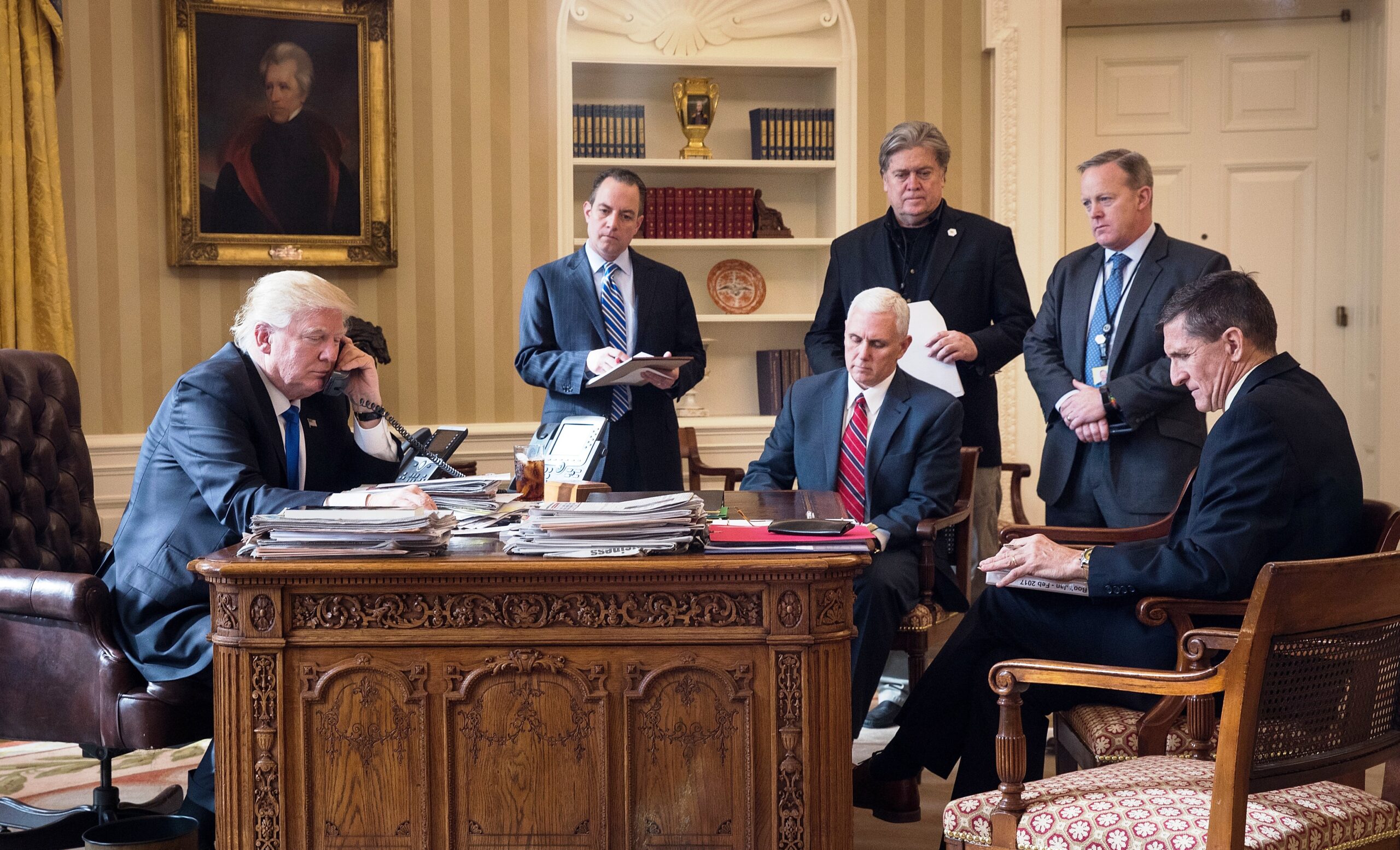 President Donald Trump speaks on the phone with Russian President Vladimir Putin in the Oval Office of the White House, Jan. 28, 2017 in Washington, D.C. Also pictured, from left, White House Chief of Staff Reince Priebus, Vice President Mike Pence, White House Chief Strategist Steve Bannon, Press Secretary Sean Spicer and National Security Advisor Michael Flynn.