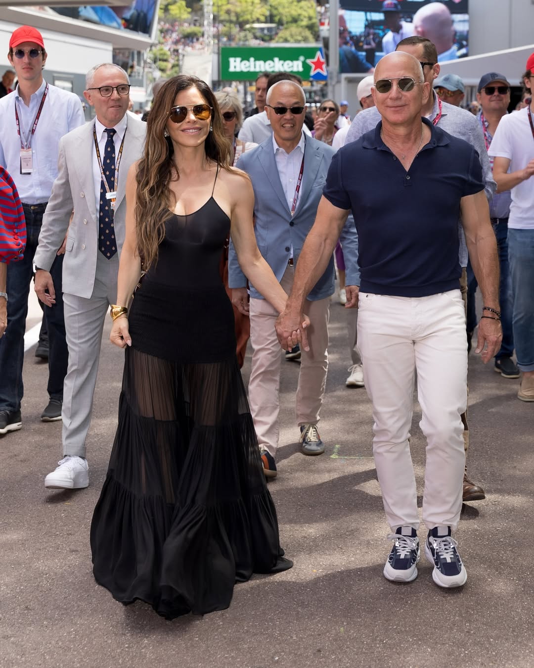 Lauren Sanchez brought her beloved fashion sense to the Monaco Grand Prix on Sunday, turning heads as she strolled through the pit lane in a sheer black gown. The 55-year-old was spotted walking hand-in-hand with (1)